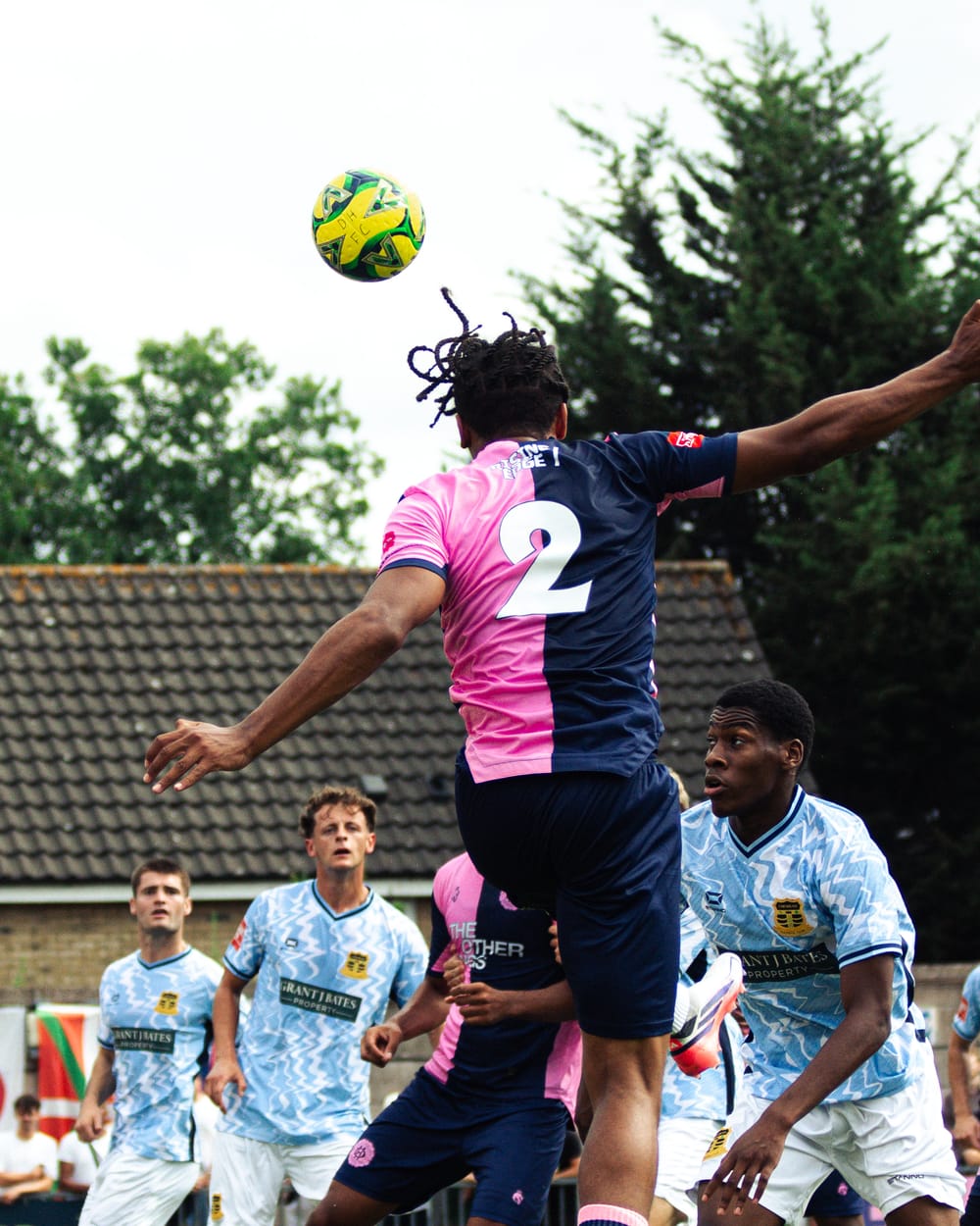 A Dulwich Hamlet player rises for a header